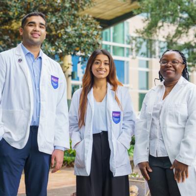 Three students in white coats