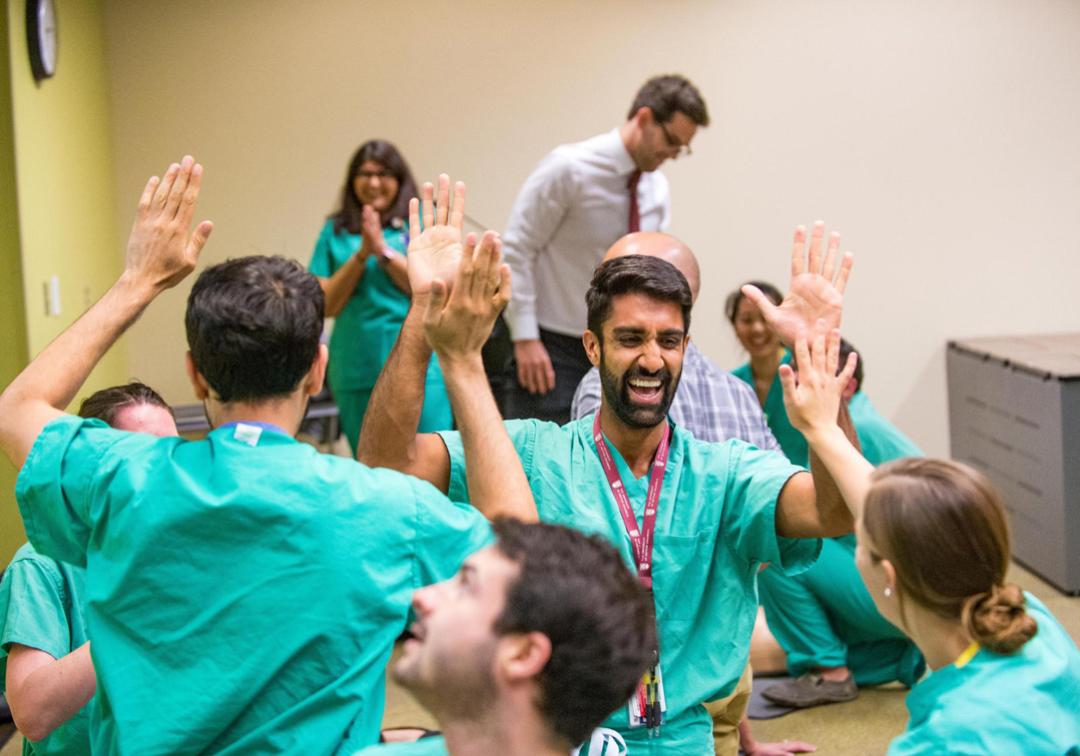 Cheering students in scrubs