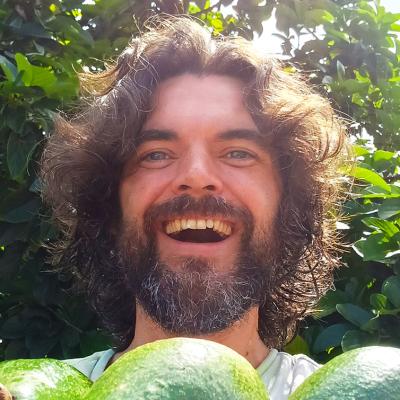 Headshot of Dr Steven Sushinsky holding some avocados