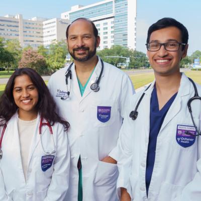 Three students in front of Ochsner building