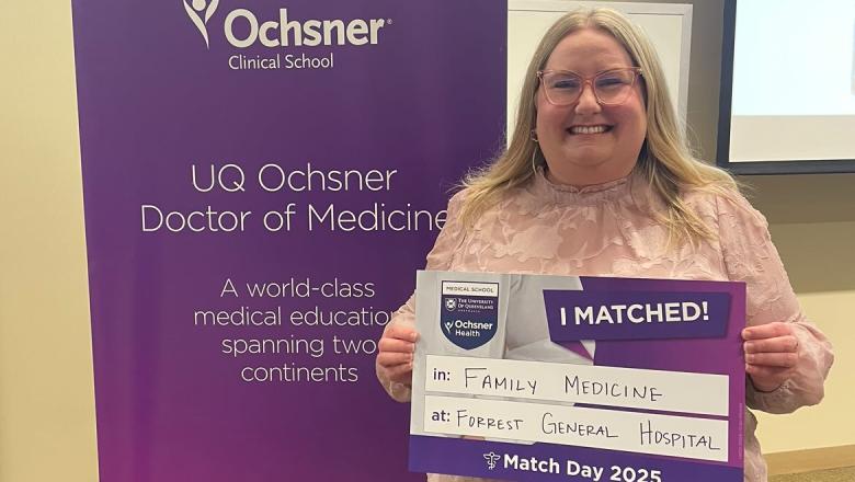 Makenna Moore holding a sign with 'I Matched!'
