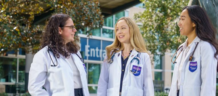 Three students in white coats