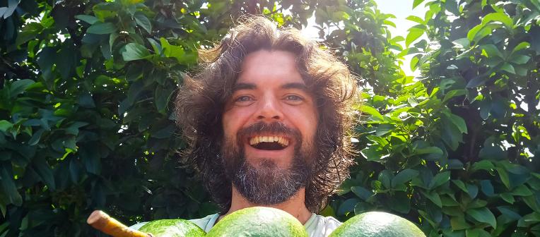 Headshot of Dr Steven Sushinsky holding some avocados