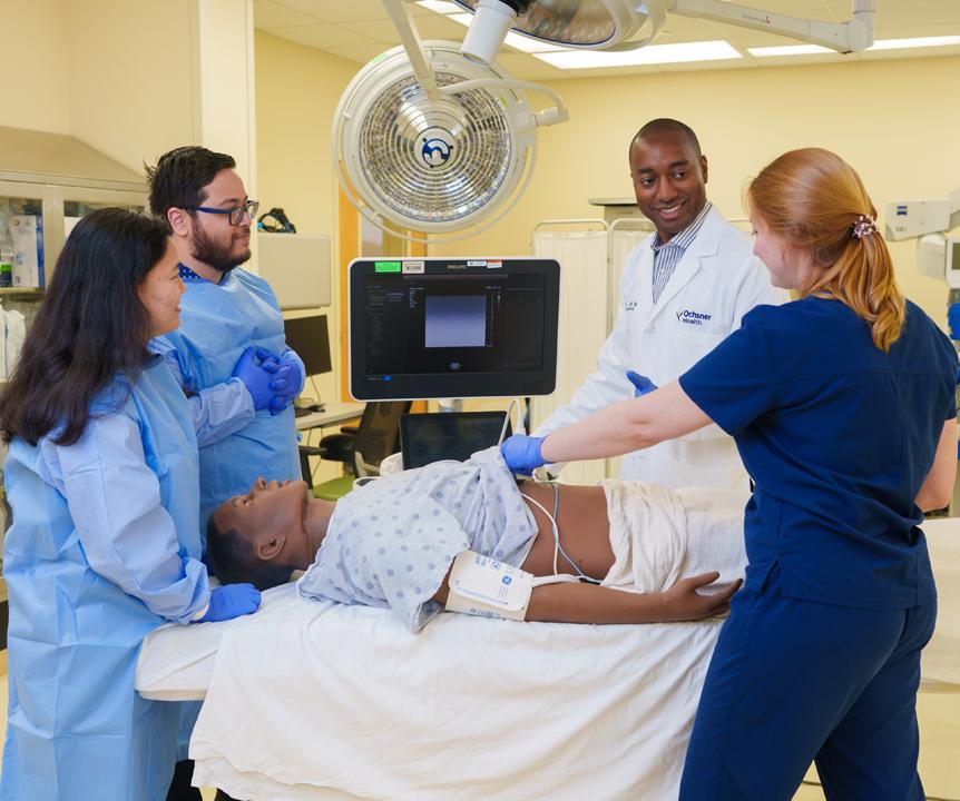 students in an operating room learning from a physician