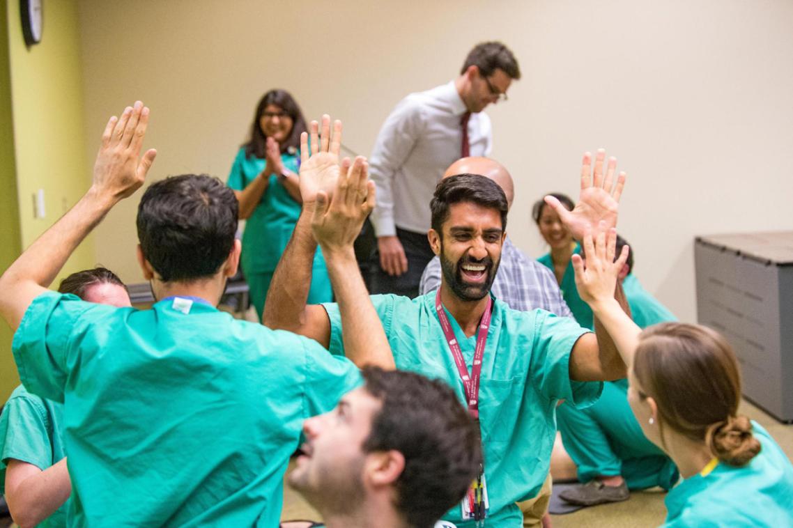 Cheering students in scrubs