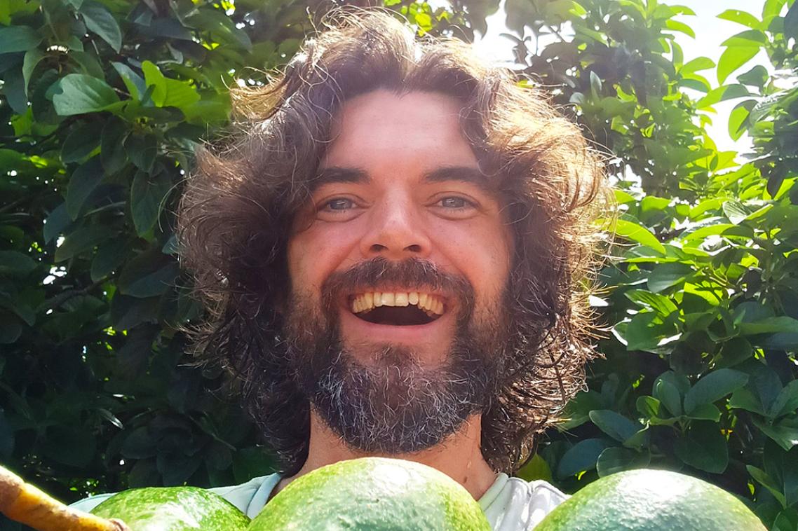 Headshot of Dr Steven Sushinsky holding some avocados